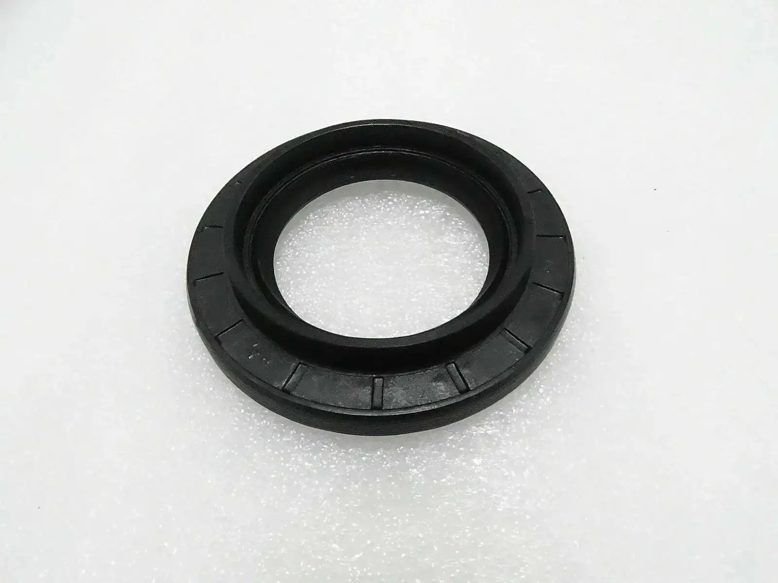 Black circular oil seal with inner sealing lip and outer housing