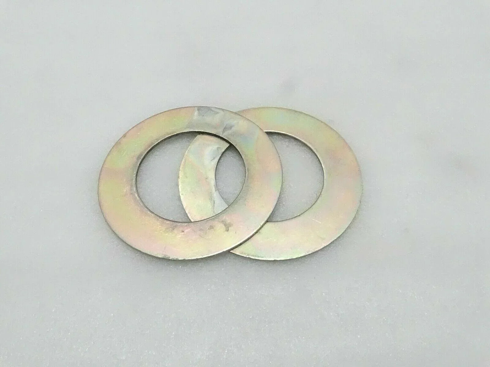 Metal shim washer pair with central holes