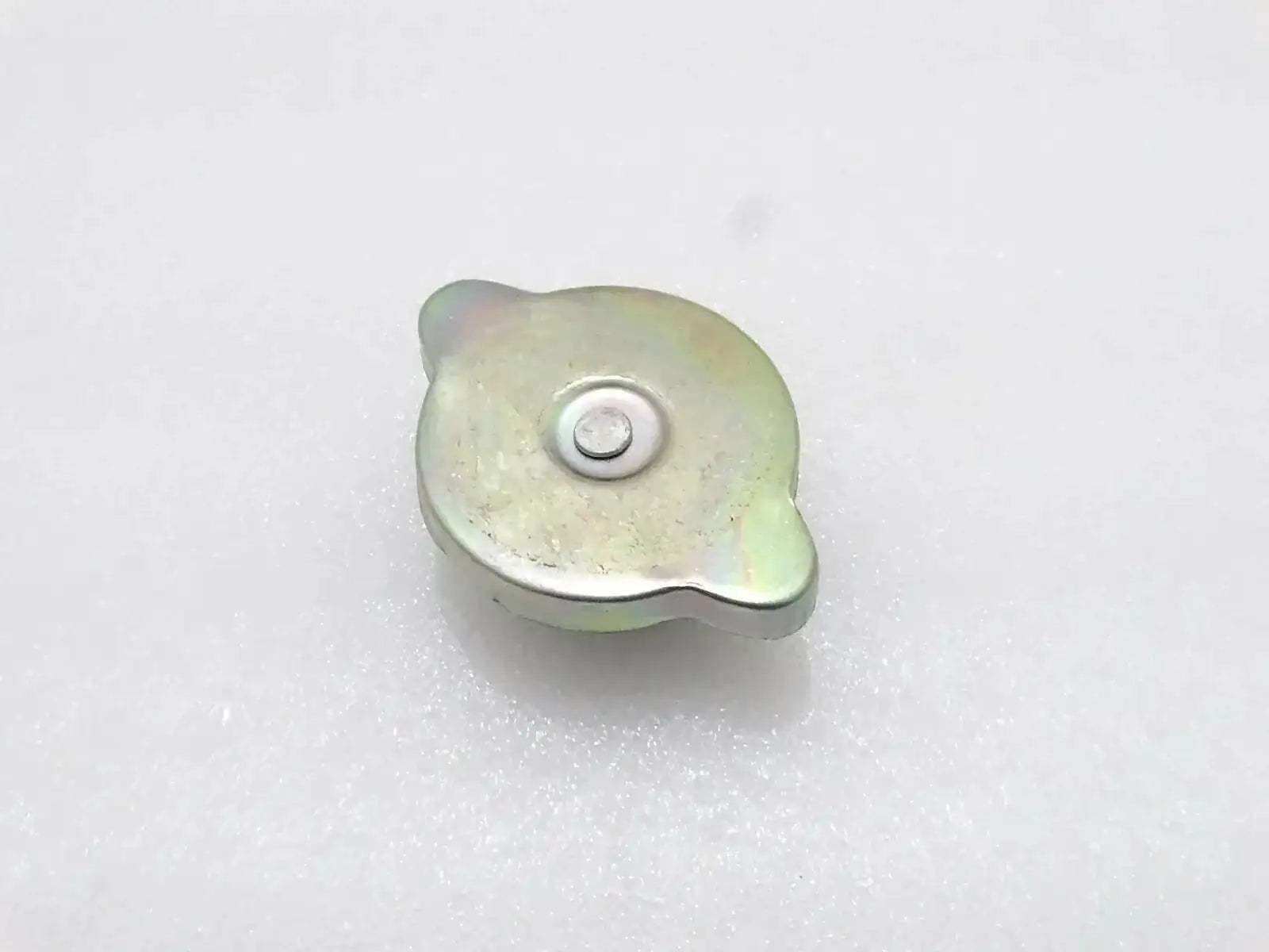 Radiator cap, light yellow-green metal with round center button