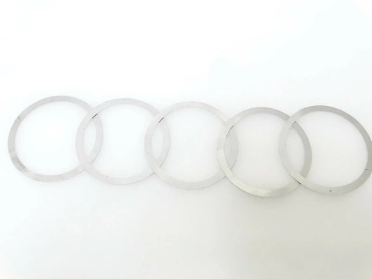 Shim kit: set of thin circular washers and rings, light gray