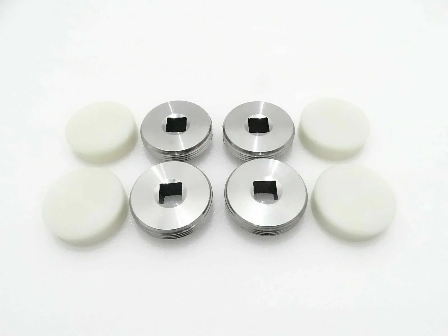 4-piece set of metal wear pads with black center and white rubber discs