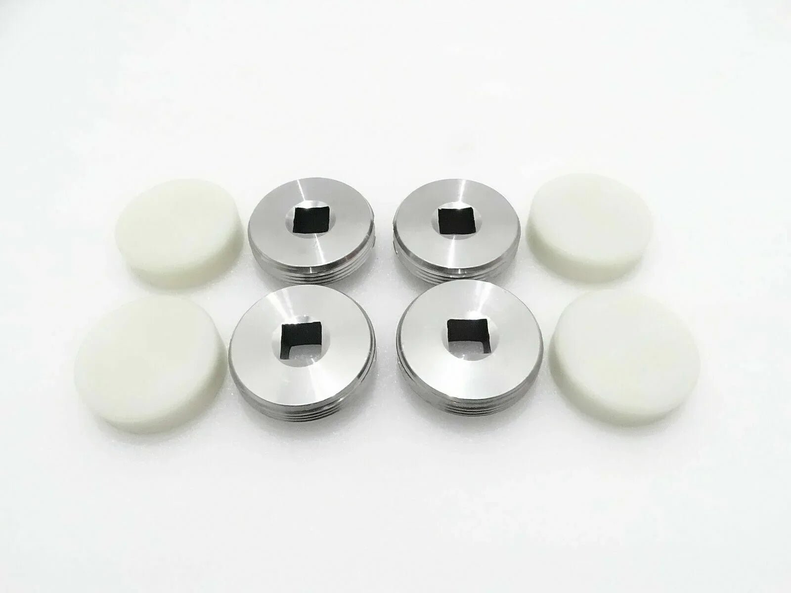 4-piece set of metal wear pads with black center and white rubber discs