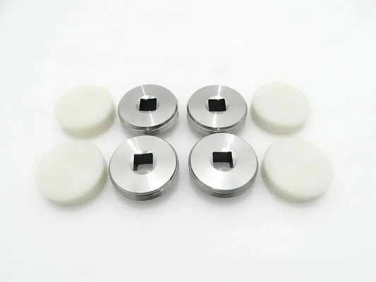4-piece set of metal wear pads with black center and white rubber discs