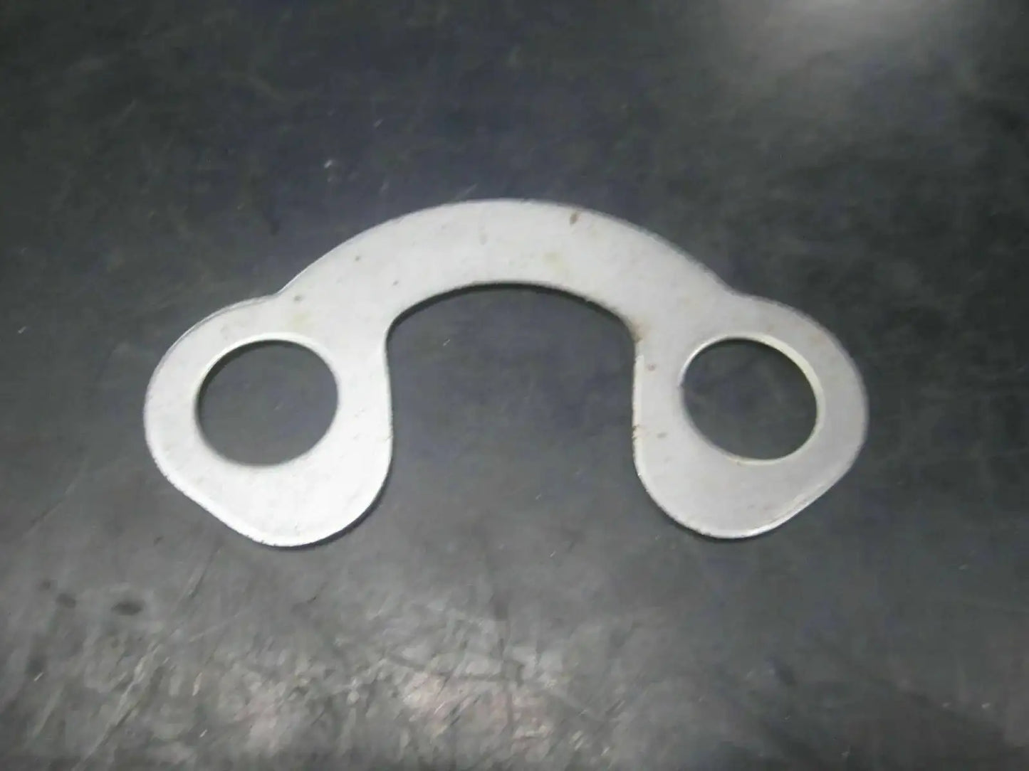 Silver metal tab washer with two holes, part 988/00055