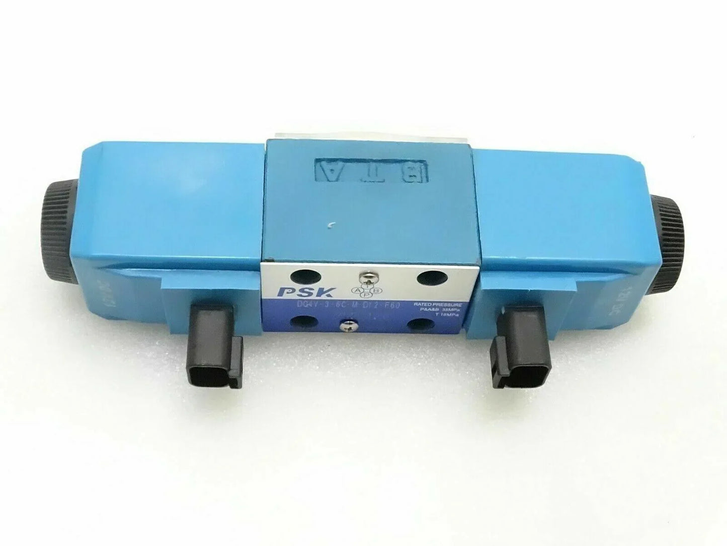 JCB valve solenoid 25/104700 replacement, durable plastic, essential for hydraulic systems.