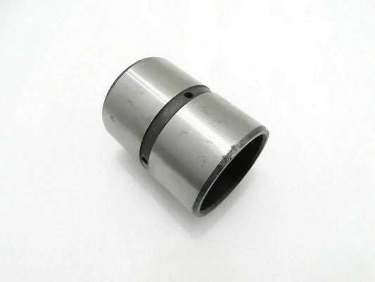 Cylindrical metal bushing with dark rubber ring