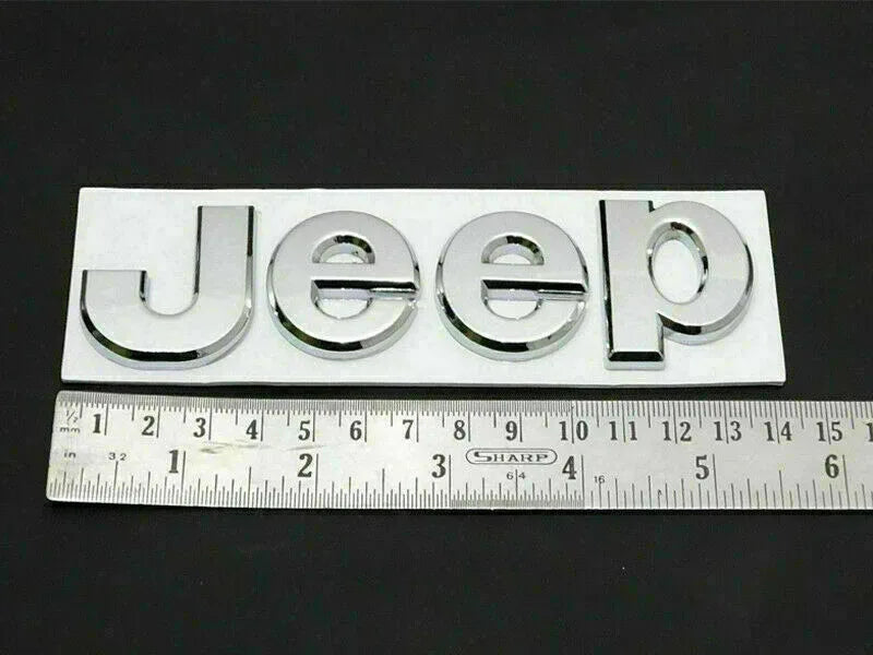 Chrome Jeep logo emblem with Jeep lettering, close-up