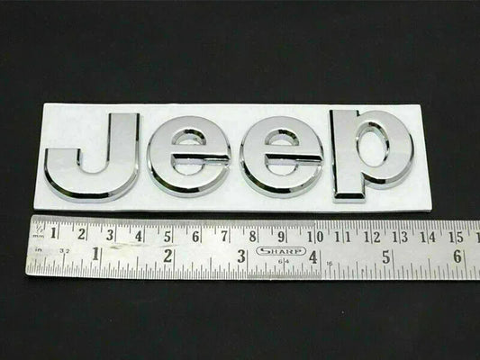 Chrome Jeep logo emblem with Jeep lettering, close-up