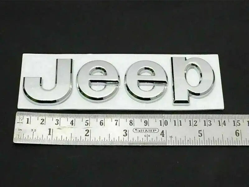 Chrome Jeep logo emblem with Jeep lettering, close-up