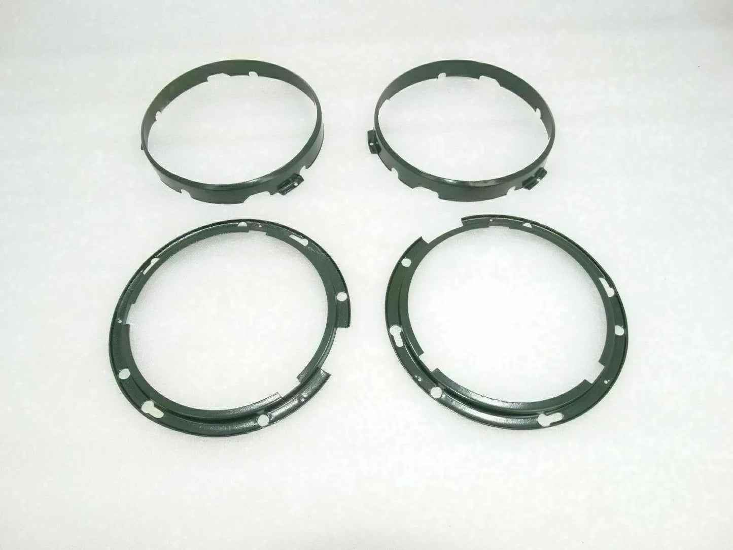 Headlight inner rim set with four dark circular rings and mounting holes