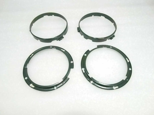 Headlight inner rim set with four dark circular rings and mounting holes