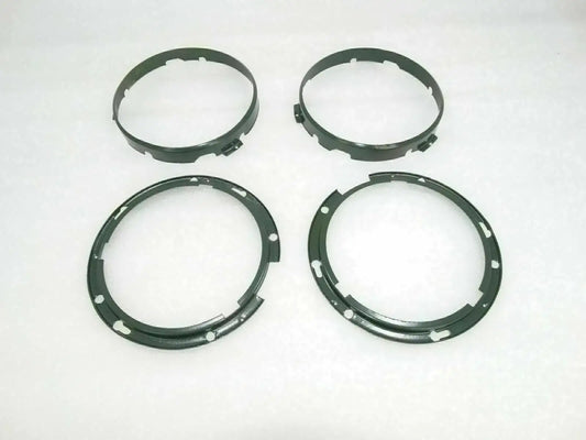Headlight inner rim set with four dark circular rings and mounting holes
