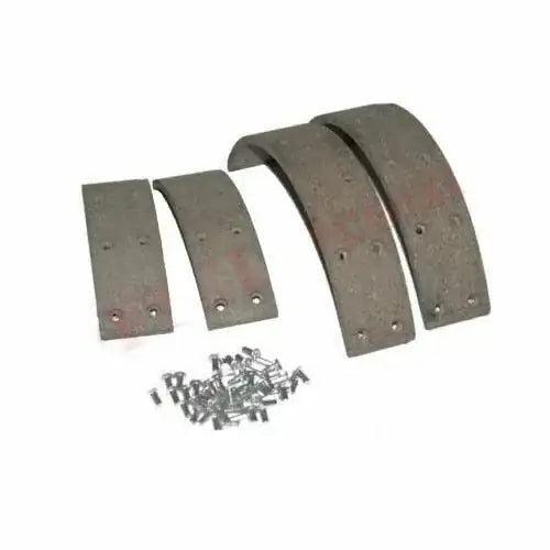 Brake shoe lining kit set with rivets: four dark gray pads with holes and loose rivets