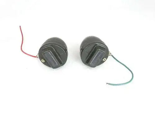 Pair of round cat-eye marker lights with wired connections, dark housings