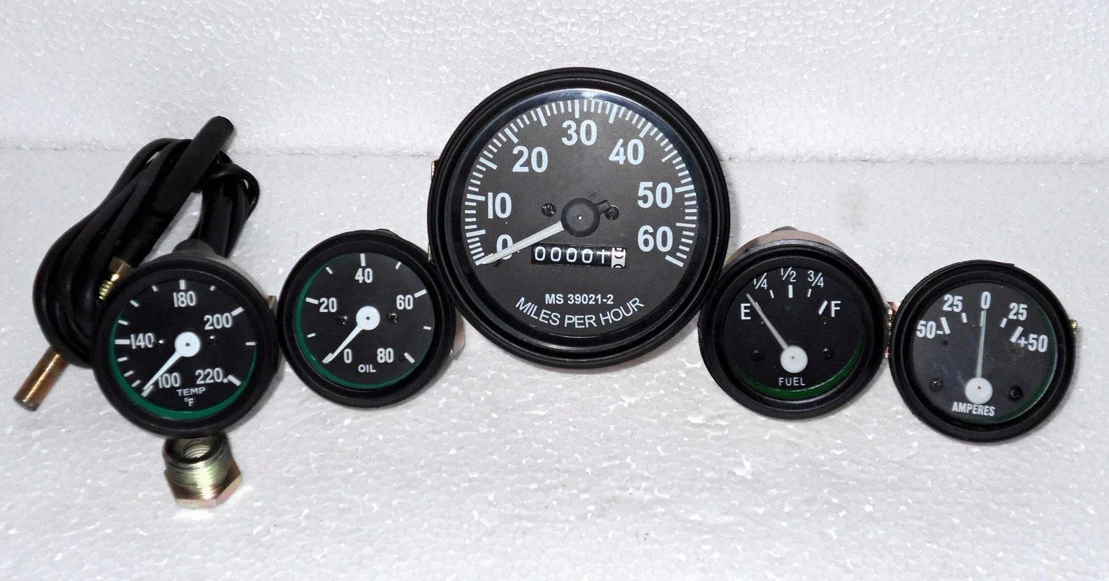 Speedometer gauge kit with five round gauges, black bezels, white markings, 12V