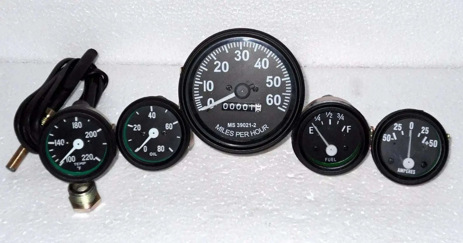 Speedometer gauge kit with five round gauges, black bezels, white markings, 12V