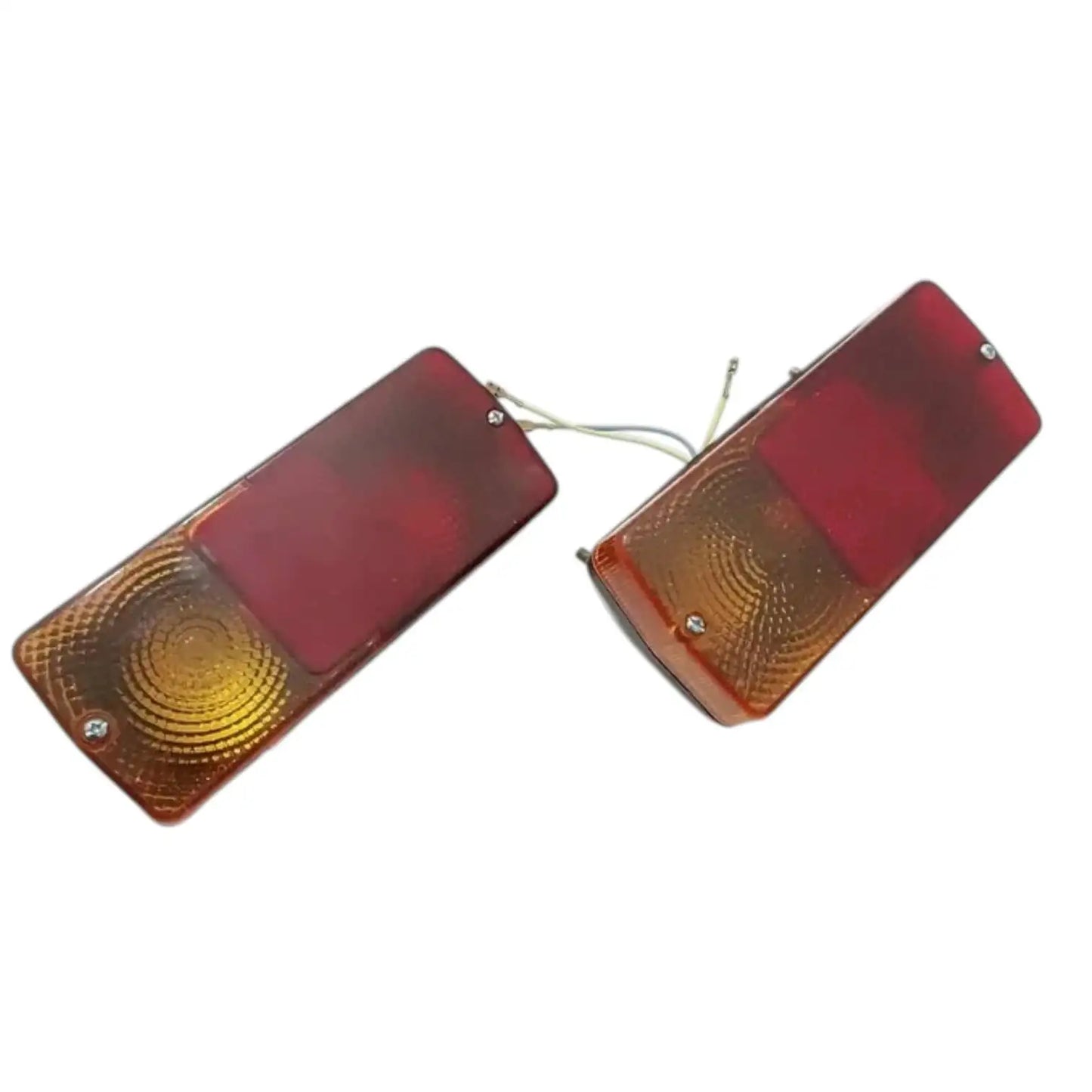 Two tractor indicator flasher lights with red covers and amber turn signal sections