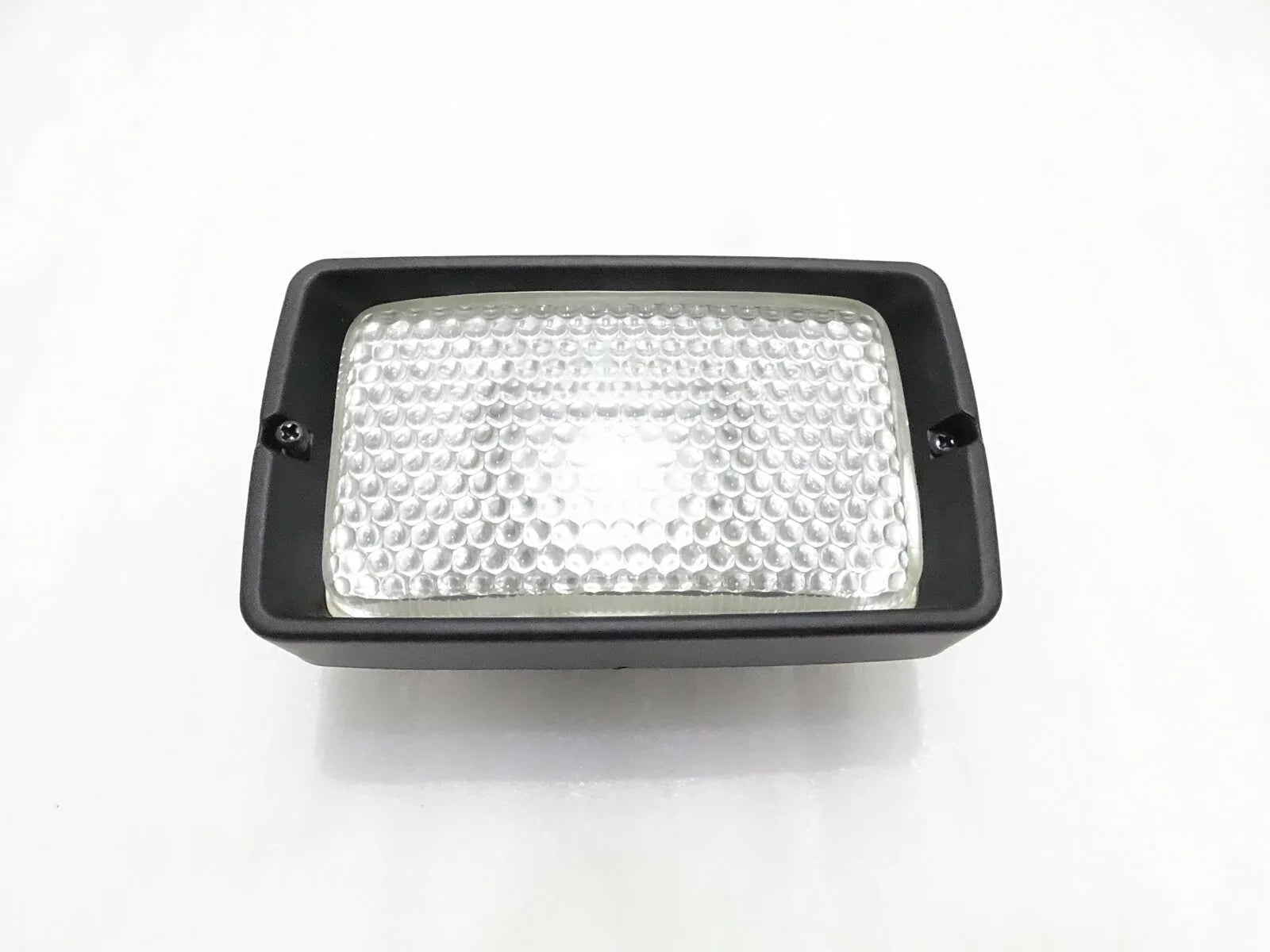Front working light, rectangular black housing with clear textured lens