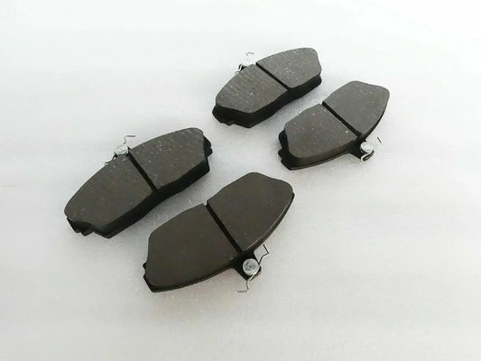 Brake disc pad set with dark friction pads and metal spring clips