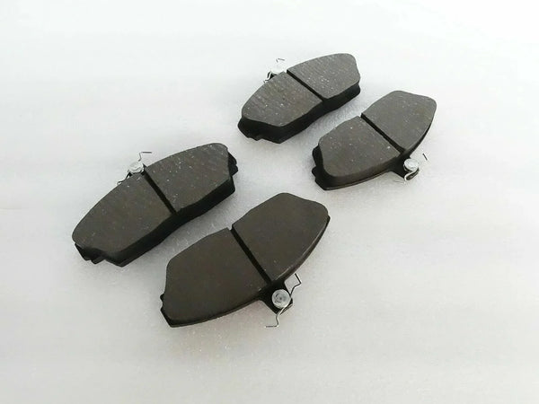 Brake disc pad set with dark friction pads and metal spring clips