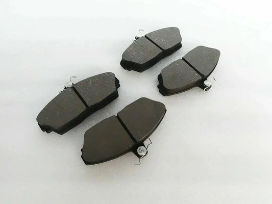 Brake disc pad set with dark friction pads and metal spring clips