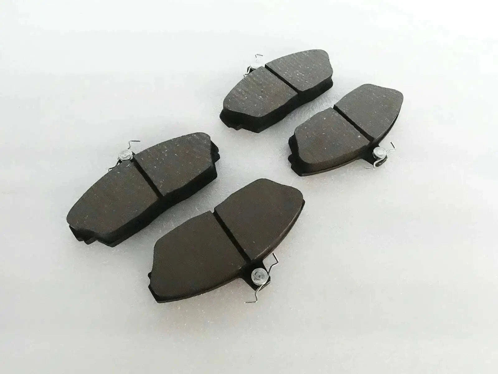 Brake disc pad set with dark friction pads and metal spring clips