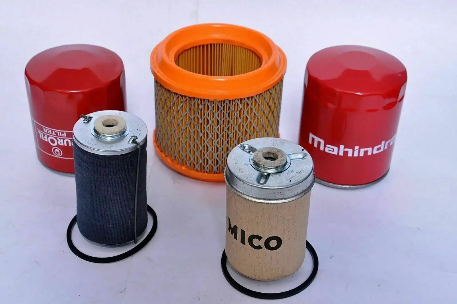 Tractor filter pack with orange pleated and red cylindrical cartridges, plus metal filter elements