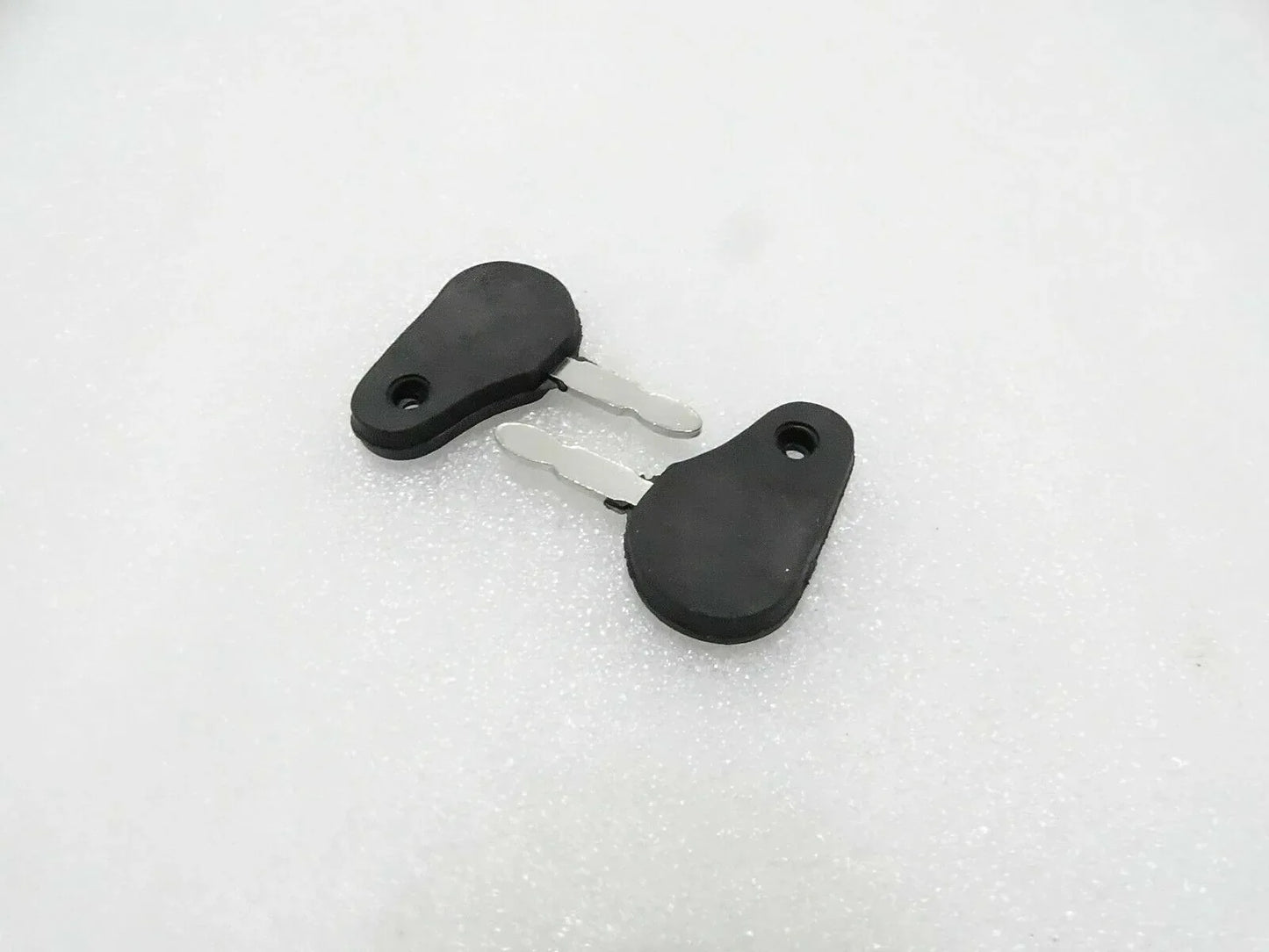 Tractor ignition starter key with black plastic head and metal blade