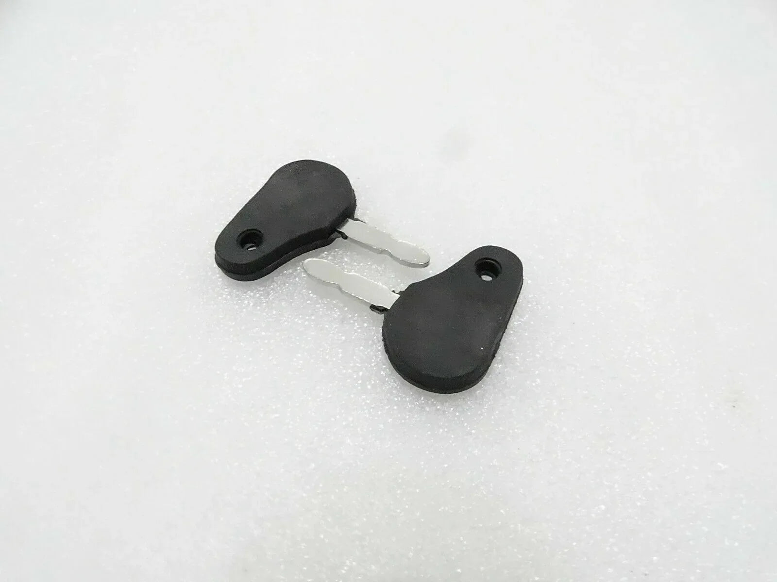 Tractor ignition starter key with black plastic head and metal blade