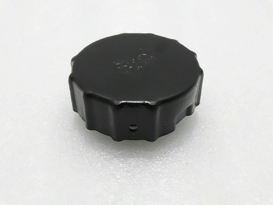 Black Mahindra tractor fuel tank cap, durable plastic, designed for secure fuel storage