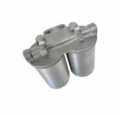 Tractor fuel filter assembly with metal housing and two capped ports