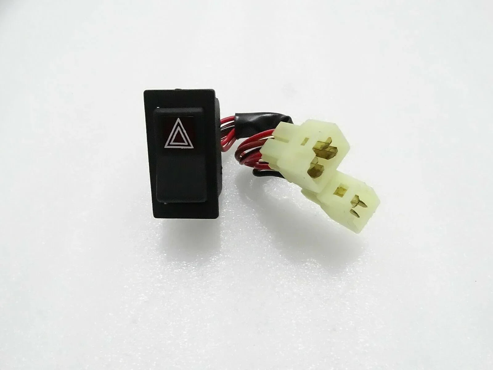 Tractor hazard switch with red triangle icon and two-pin wire connector