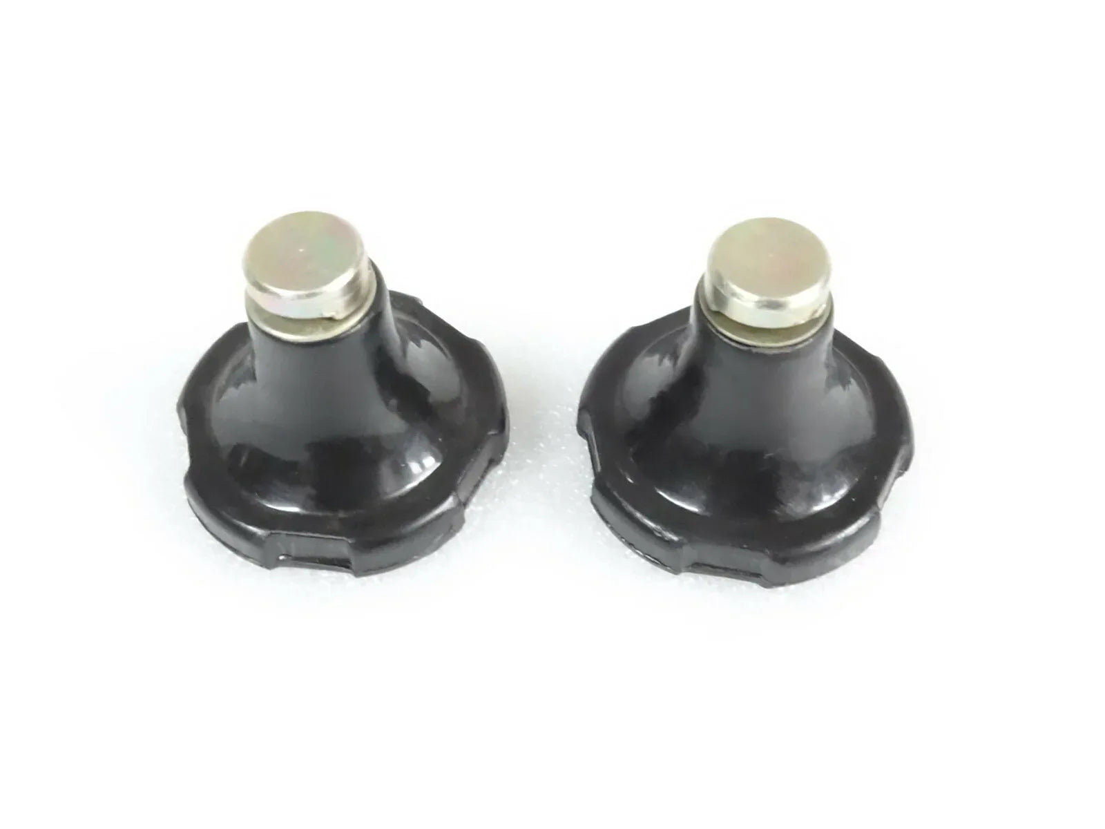 Pair of black hydraulic lift stop knobs with silver caps