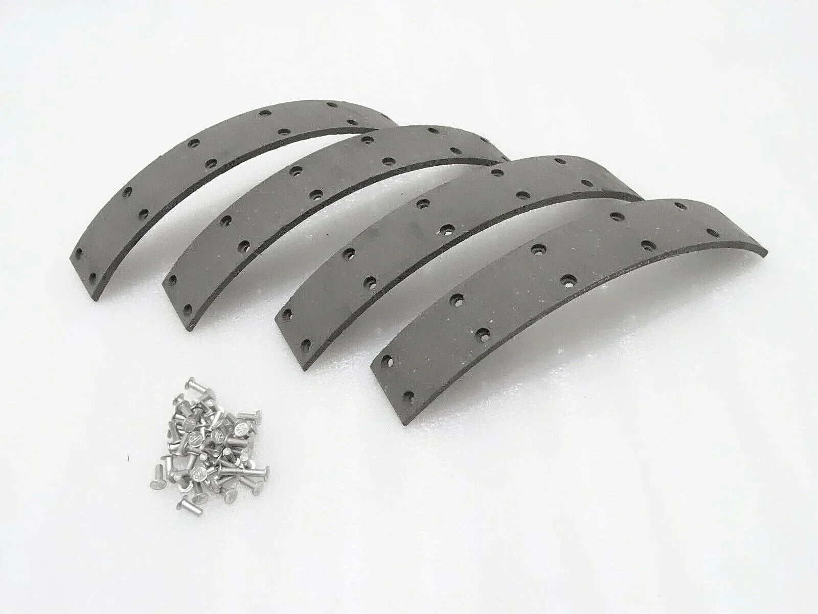 Rubber brake set for Massey Ferguson model with four curved pieces and mounting screws included