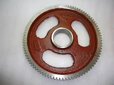 Rust-brown timing gear wheel with gear teeth and central mounting hole