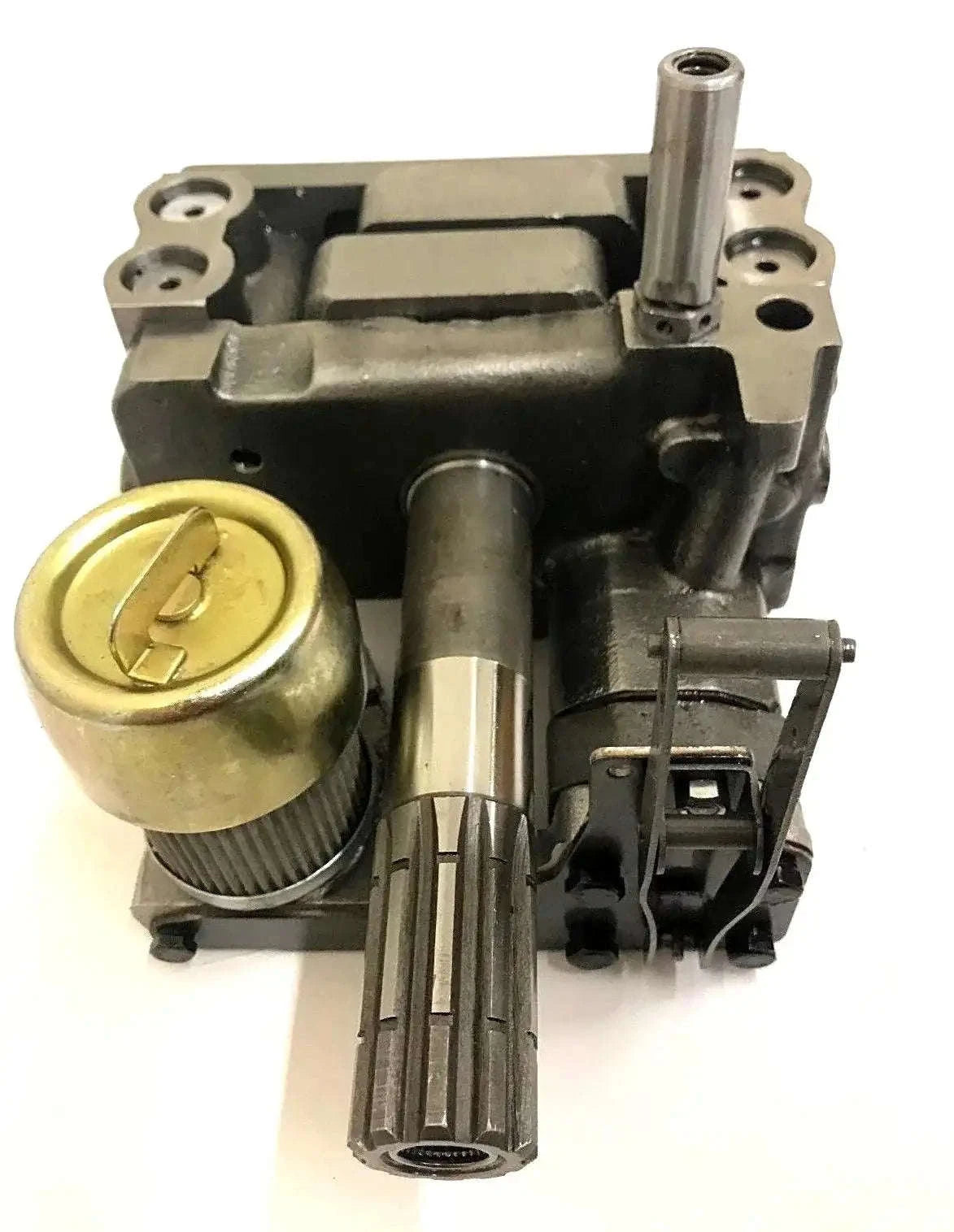 Hydraulic pump assembly with brass cap and metal shafts on black housing