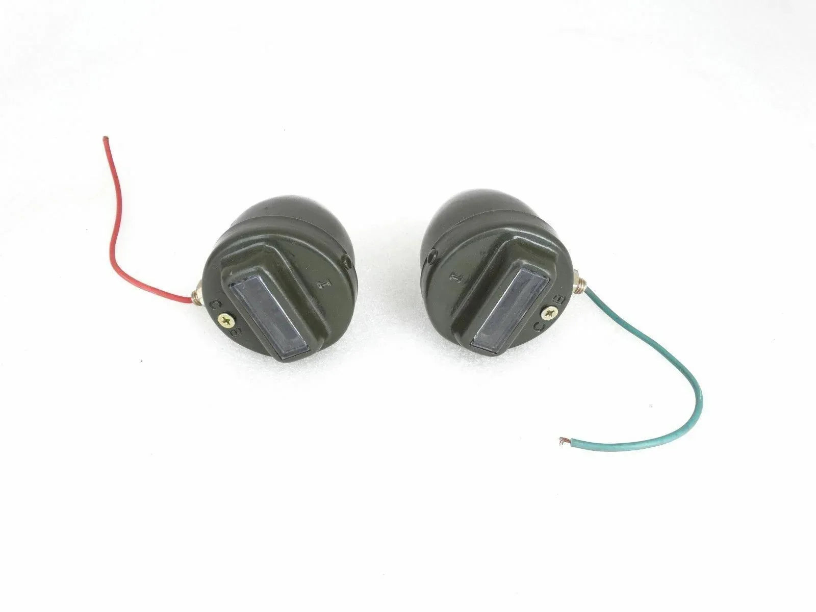 Pair of black cat-eye marker lights with wiring harness, round with clear lens