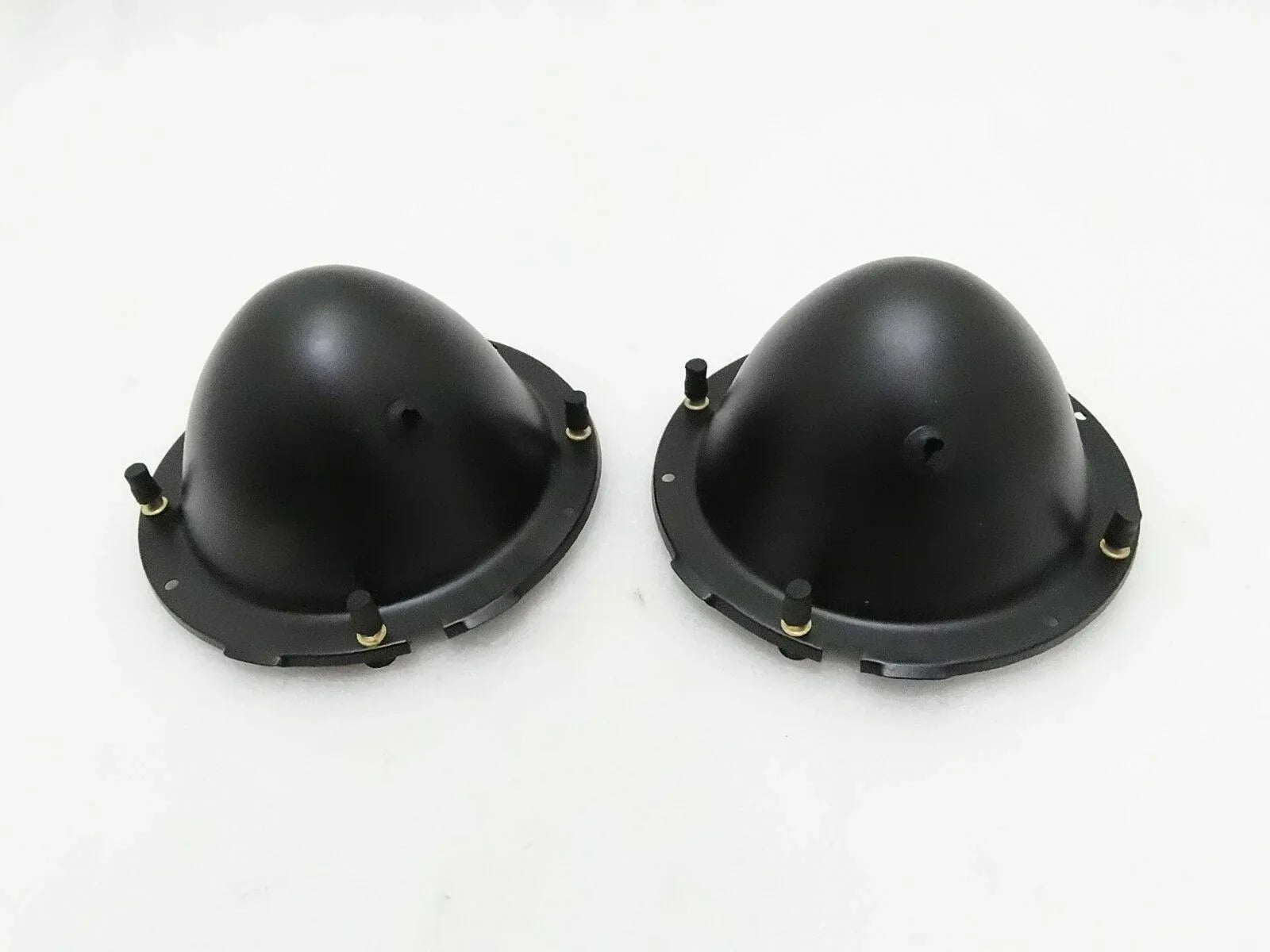 Pair of black headlight holding buckets with mounting tabs and screws
