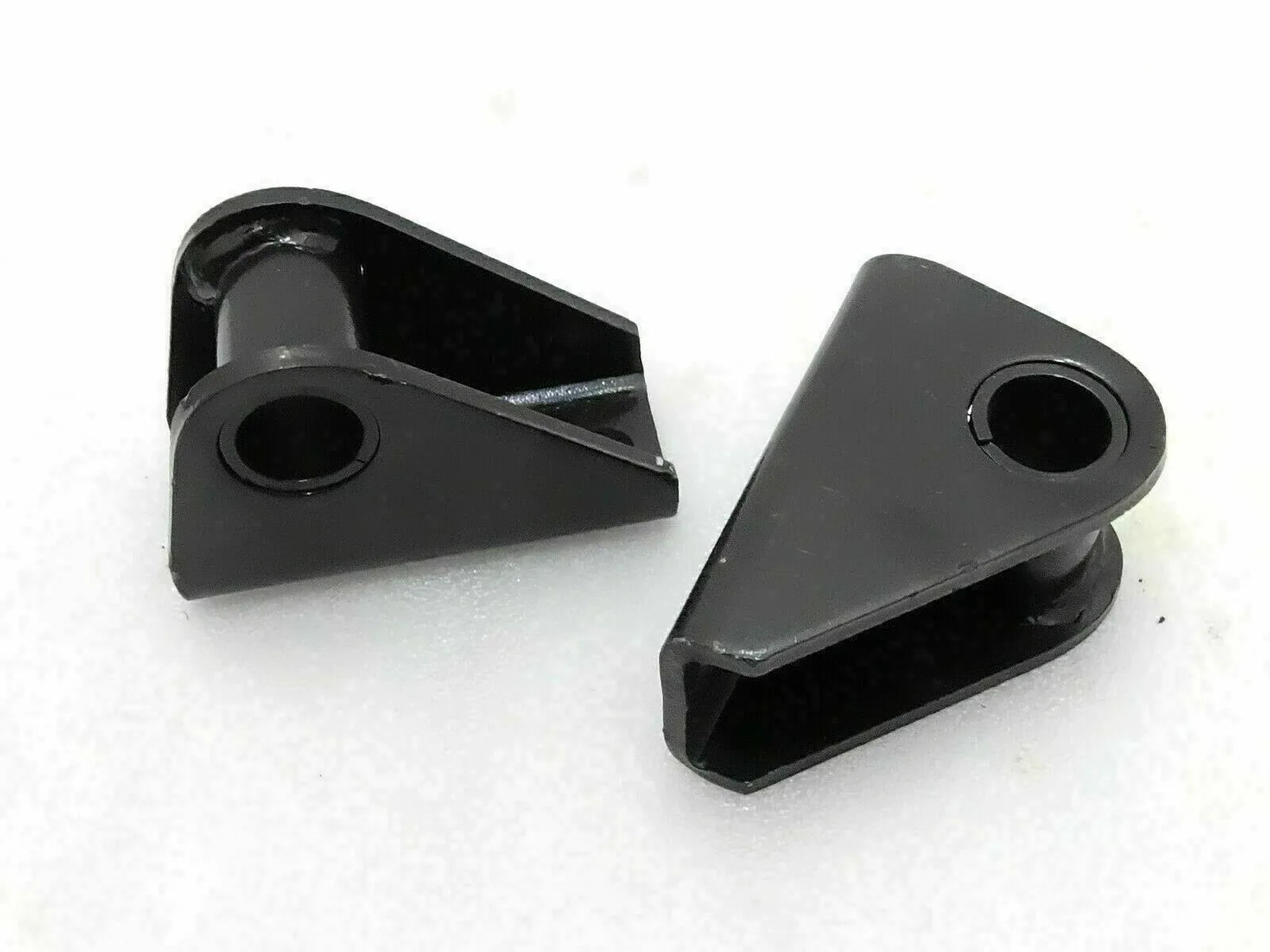Suspension shackle bracket kit with two black metal brackets and mounting holes