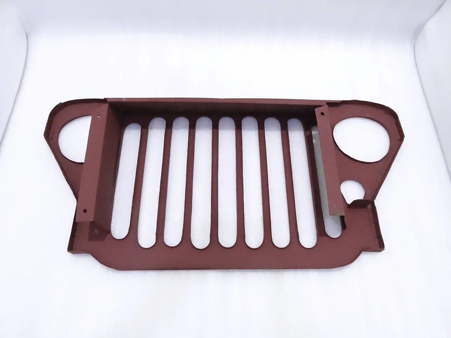 Steel front grille with vertical slats and two round openings, dark brown finish