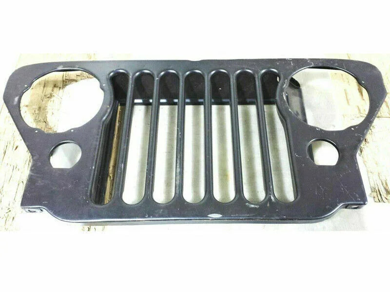 Black front grille panel with two round openings and vertical slots