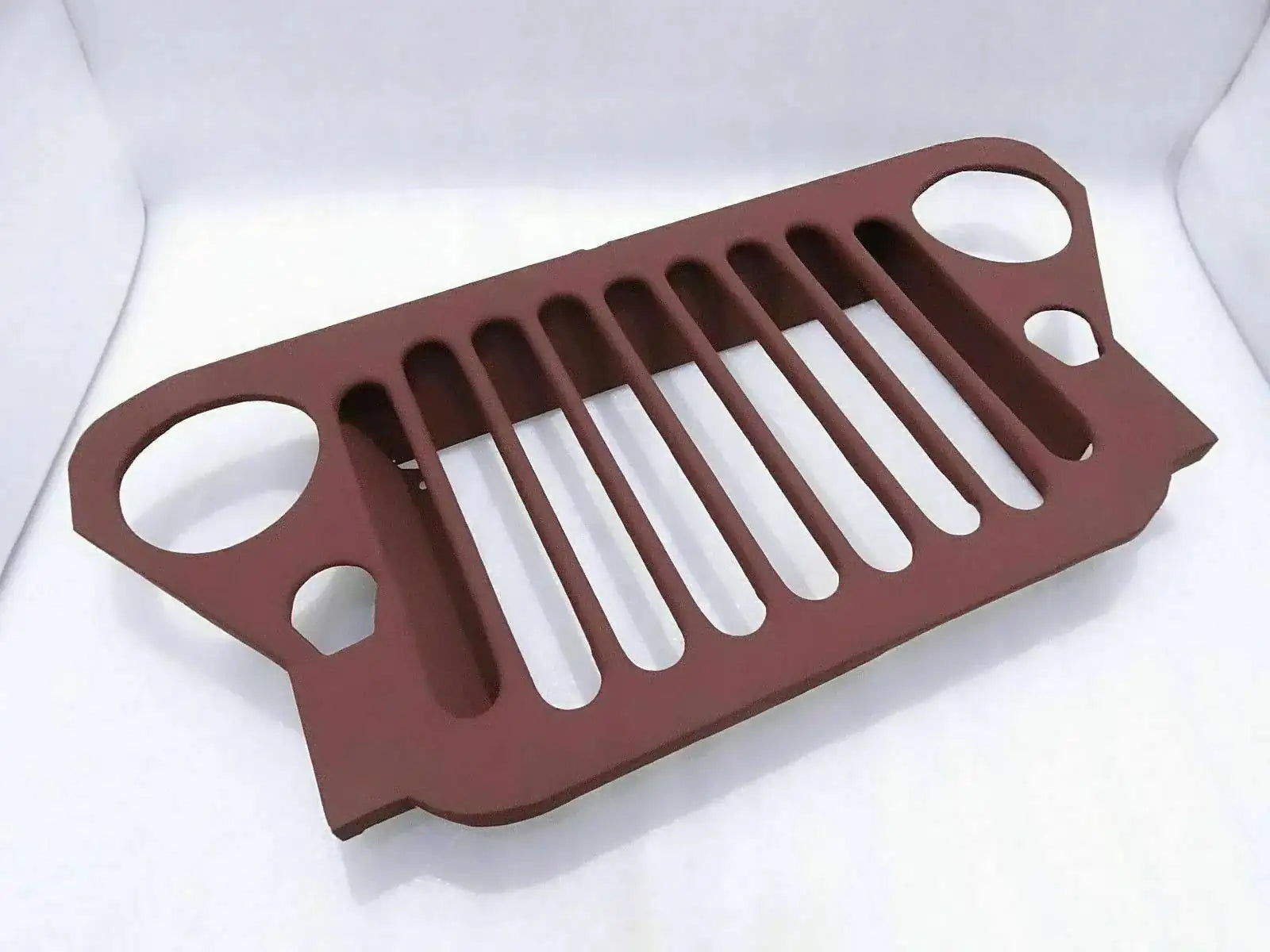 Primer-coated steel radiator grille with maroon finish and vertical slotted openings