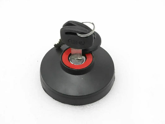 Black locking fuel tank cap with red seal and keys