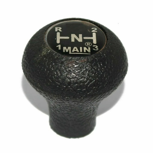 Black textured gear shift knob with gear position markings on top
