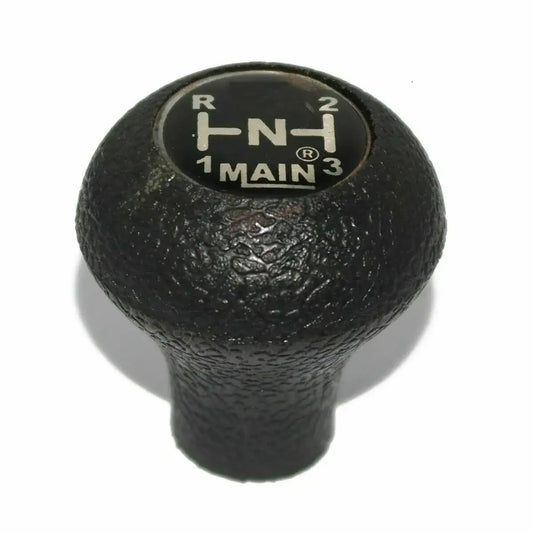 Black textured gear shift knob with gear position markings on top