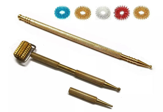 Metal acupressure roller and probe set with colorful rings for therapeutic use.