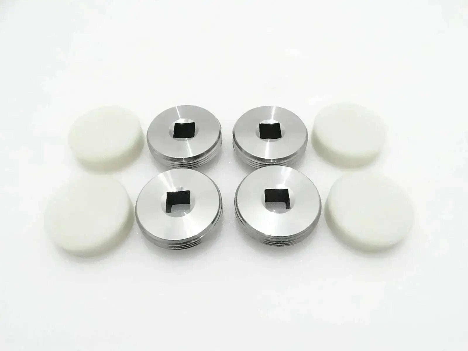 4-piece set of metal wear pads with black center and white rubber discs