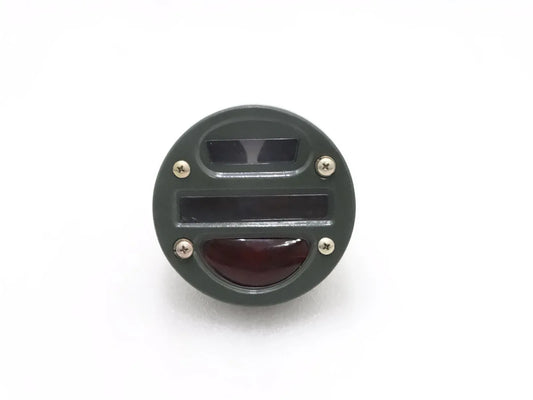 Round tail light cat-eye with clear top lens and red lower lens, black housing.