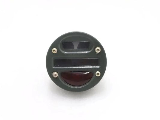 Round tail light cat-eye with clear top lens and red lower lens, black housing.