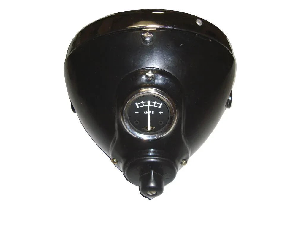 Black headlamp housing with circular lens and mounting bracket, triangular cover